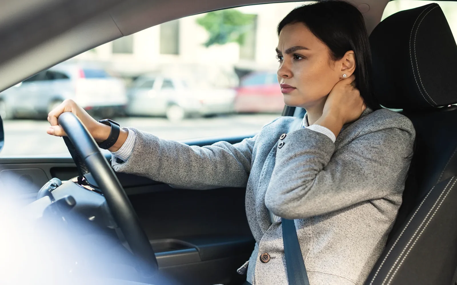 Driver holding her neck with delayed symptoms after a car accident