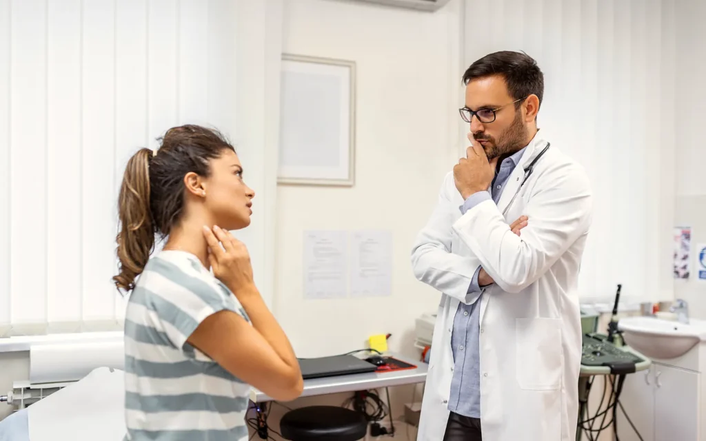 Patient describing neck pain to a GP after a car accident
